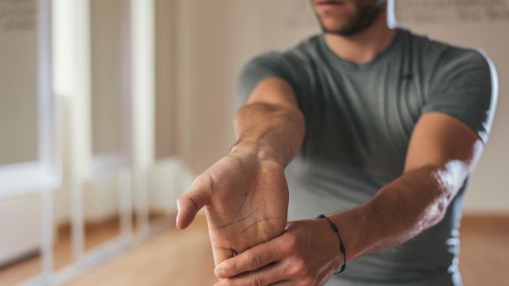 Occupational therapist showing hand therapy stretch